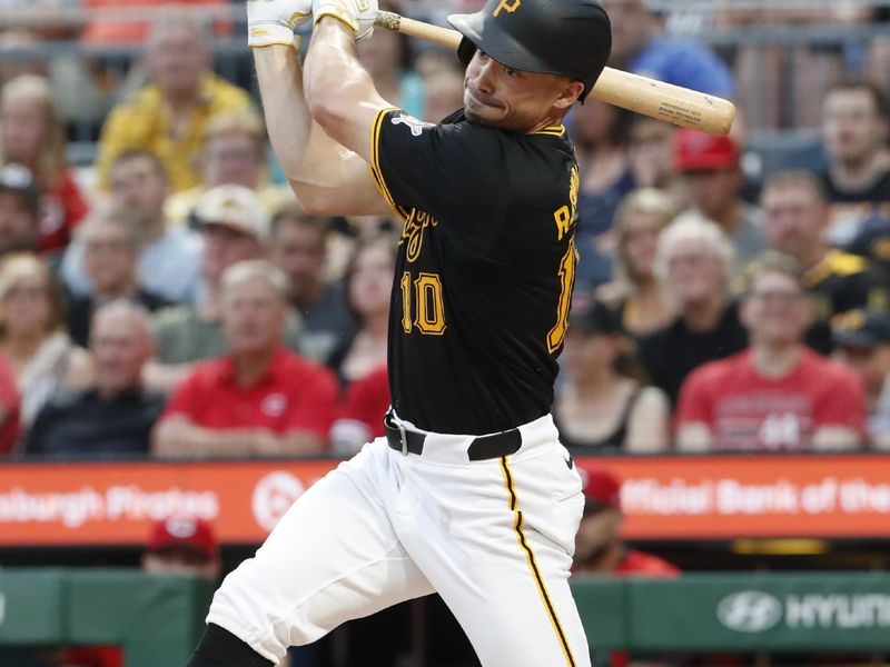 Jun 17, 2024; Pittsburgh, Pennsylvania, USA;  Pittsburgh Pirates left fielder Bryan Reynolds (10) hits an RBI double against the Cincinnati Reds during the second inning at PNC Park. Mandatory Credit: Charles LeClaire-USA TODAY Sports