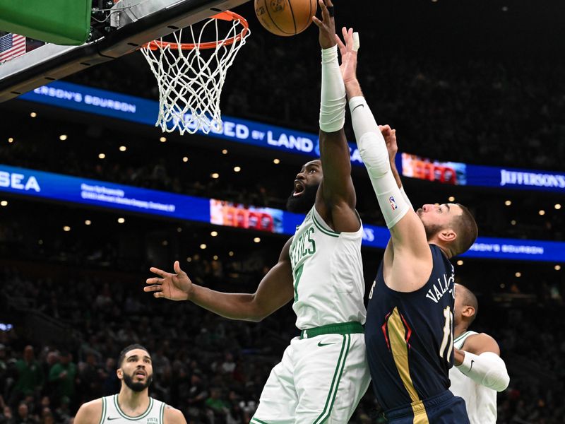 BOSTON, MASSACHUSETTS - JANUARY 29: Jaylen Brown #7 of the Boston Celtics rebounds the ball against Jonas Valanciunas #17 of the New Orleans Pelicans during the third quarter at the TD Garden on January 29, 2024 in Boston, Massachusetts. NOTE TO USER: User expressly acknowledges and agrees that, by downloading and or using this photograph, User is consenting to the terms and conditions of the Getty Images License Agreement. (Photo by Brian Fluharty/Getty Images)