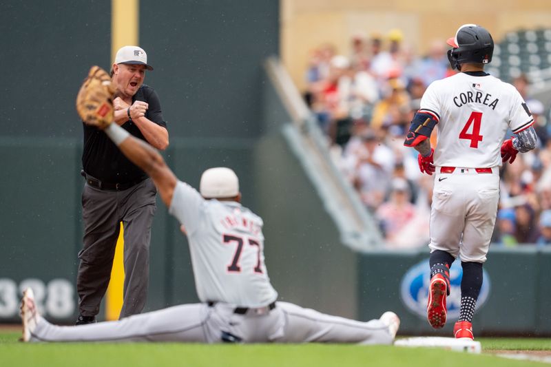 Jul 4, 2024; Minneapolis, Minnesota, USA; Umpire Chad Whitson (62) calls Minnesota Twins shortstop Carlos Correa (4) out at first after Detroit Tigers second base Andy Ibanez (77) catches the ball at Target Field. Mandatory Credit: Matt Blewett-USA TODAY Sports