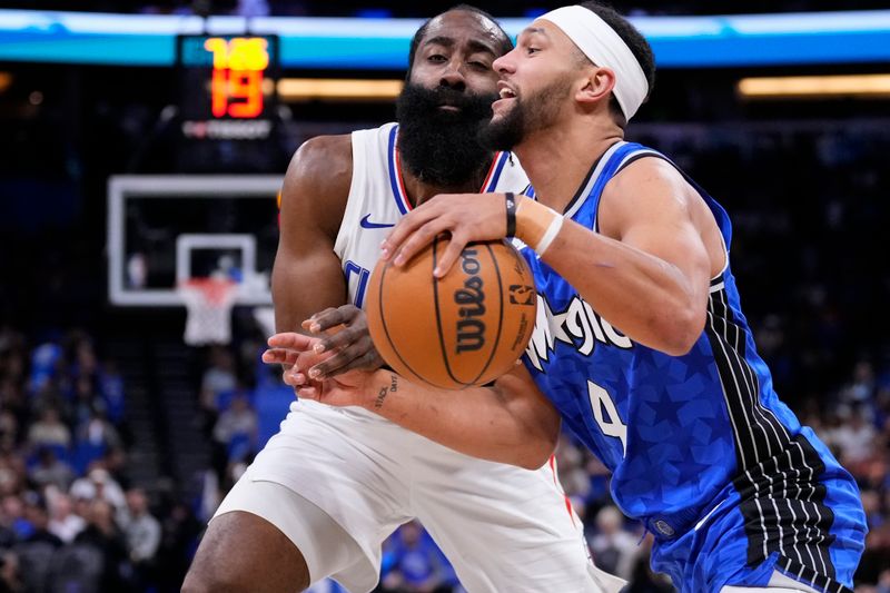 ORLANDO, FLORIDA - MARCH 29: Jalen Suggs #4 of the Orlando Magic goes to the basket against James Harden #1 of the Los Angeles Clippers during the first quarter at Kia Center on March 29, 2024 in Orlando, Florida. NOTE TO USER: User expressly acknowledges and agrees that, by downloading and or using this photograph, User is consenting to the terms and conditions of the Getty Images License Agreement. (Photo by Rich Storry/Getty Images)