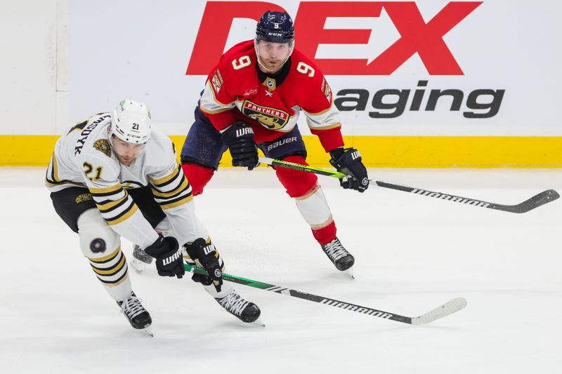 Nov 22, 2023; Sunrise, Florida, USA; Boston Bruins left wing James van Riemsdyk (21) and Florida Panthers center Sam Bennett (9) watch the puck during the third period at Amerant Bank Arena. Mandatory Credit: Sam Navarro-USA TODAY Sports