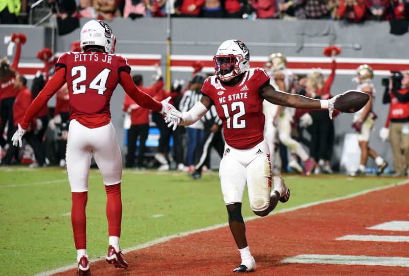 Oct 8, 2022; Raleigh, North Carolina, USA; North Carolina State Wolfpack safety Devin Boykin (12) celebrates after the game-clinching interception during the second half against the Florida State Seminoles at Carter-Finley Stadium. Mandatory Credit: Rob Kinnan-USA TODAY Sports