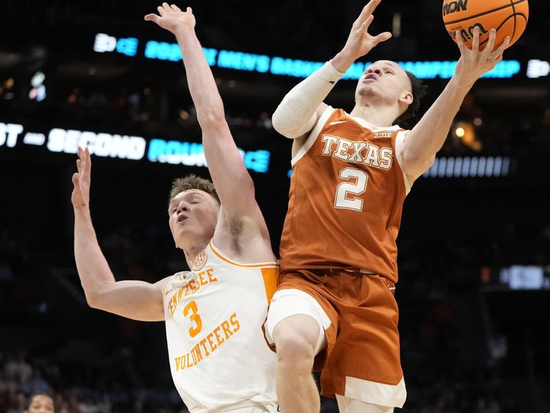 March 23, 2024, Charlotte, NC, USA; Texas Longhorns guard Chendall Weaver (2) shoots against Tennessee Volunteers guard Dalton Knecht (3)  in the second round of the 2024 NCAA Tournament at the Spectrum Center. Mandatory Credit: Bob Donnan-USA TODAY Sports