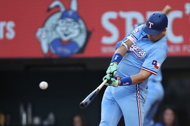 Sep 8, 2024; Arlington, Texas, USA; Texas Rangers first base Nathaniel Lowe (30) singles in the eighth inning against the Los Angeles Angels at Globe Life Field. Mandatory Credit: Tim Heitman-Imagn Images