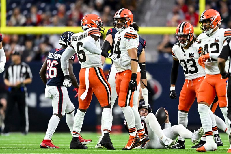 Cleveland Browns linebacker Sione Takitaki (44) and linebacker Jeremiah Owusu-Koramoah (6) react during an NFL football game against the Houston Texans, Sunday, Dec 24, 2023, in Houston. (AP Photo/Maria Lysaker)