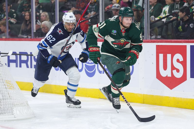 Sep 30, 2025; Saint Paul, Minnesota, USA; Minnesota Wild forward Vladimir Tarasenko (91) and Winnipeg Jets forward Nino Niederreiter (62) compete for the puck during the first period at Grand Casino Arena. Mandatory Credit: Matt Krohn-Imagn Images