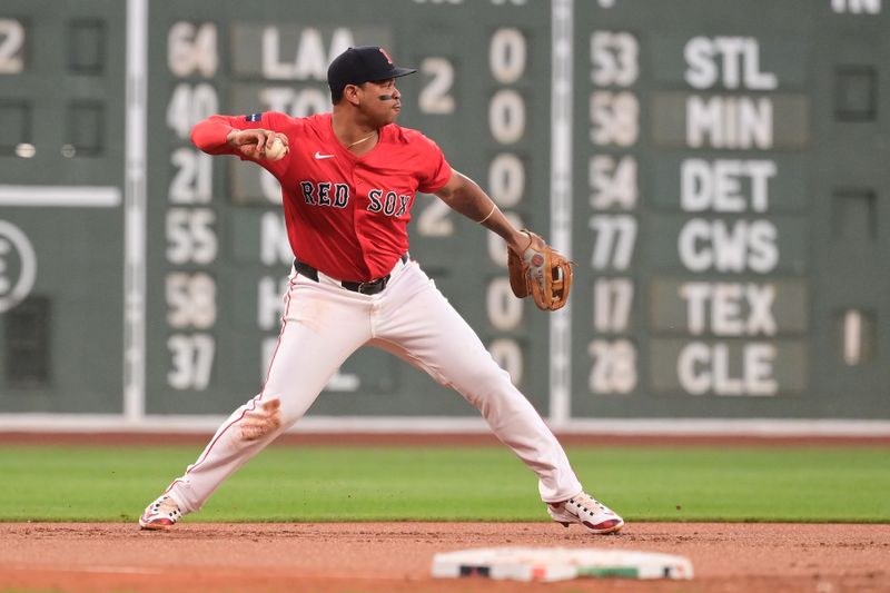 Aug 23, 2024; Boston, Massachusetts, USA; Boston Red Sox third baseman Rafael Devers (11) makes a throw for an out to end the first inning against the Arizona Diamondbacks at Fenway Park. Mandatory Credit: Eric Canha-USA TODAY Sports