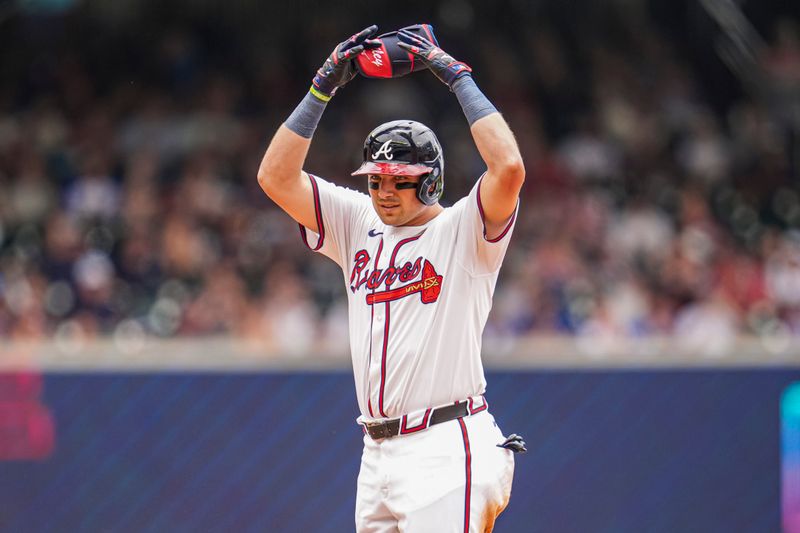 Jun 19, 2024; Cumberland, Georgia, USA; Atlanta Braves third baseman Austin Riley (27) reacts after hitting a double against the Detroit Tigers during the third inning at Truist Park. Mandatory Credit: Dale Zanine-USA TODAY Sports