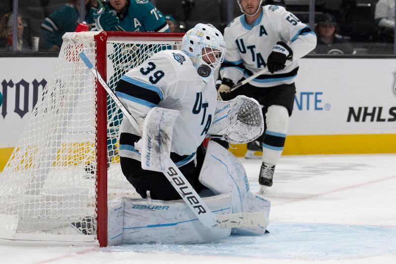 Oct 1, 2024; San Jose, California, USA;  Utah Hockey Club goaltender Connor Ingram (39) deflects the puck off his shoulder during the second period against the San Jose Sharks at SAP Center at San Jose. Mandatory Credit: Stan Szeto-Imagn Images
