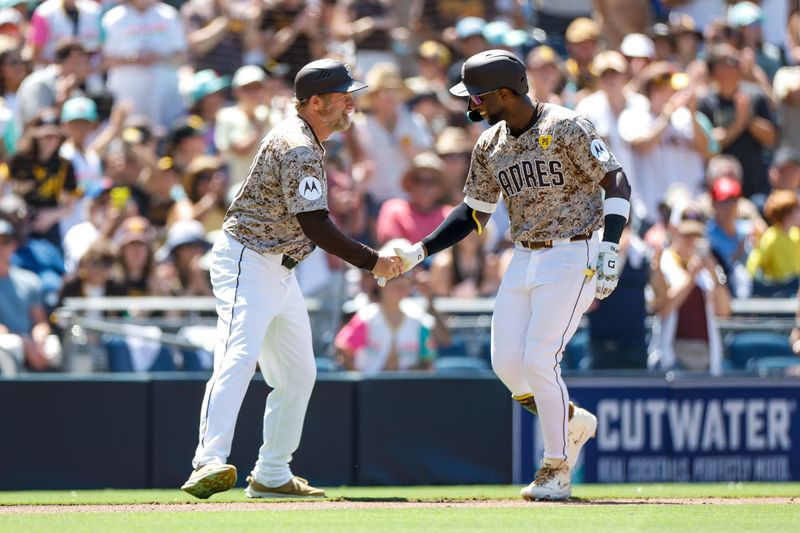 Aug 4, 2024; San Diego, California, USA; San Diego Padres left fielder Jurickson Profar (10) celebrates with  third Base Coach Tim Leiper (33) after hitting a one run home run during the fifth inning against the Colorado Rockies  at Petco Park. Mandatory Credit: David Frerker-USA TODAY Sports