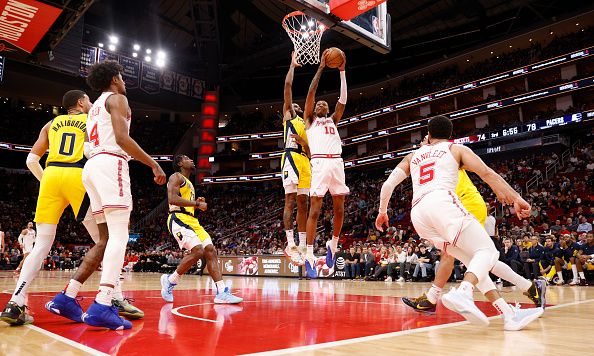 HOUSTON, TEXAS - DECEMBER 26: Jabari Smith Jr. #10 of the Houston Rockets goes up for a shot while defended by Isaiah Jackson #22 of the Indiana Pacers in the second half at Toyota Center on December 26, 2023 in Houston, Texas.  NOTE TO USER: User expressly acknowledges and agrees that, by downloading and or using this photograph, User is consenting to the terms and conditions of the Getty Images License Agreement. (Photo by Tim Warner/Getty Images)