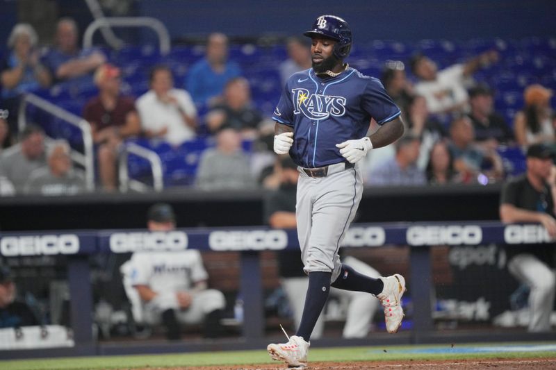 Jun 4, 2024; Miami, Florida, USA; Tampa Bay Rays left fielder Randy Arozarena (56) scores a run in the fifth inning against the Miami Marlins at loanDepot Park. Mandatory Credit: Jim Rassol-USA TODAY Sports