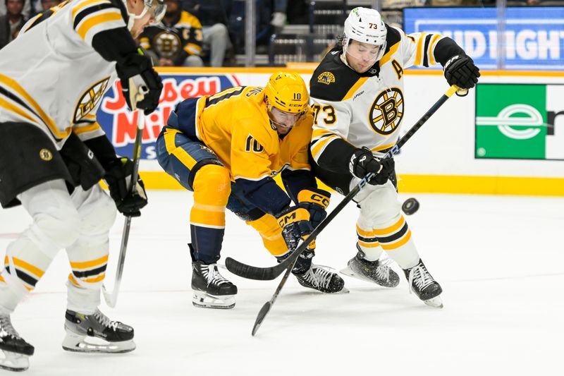 Oct 22, 2024; Nashville, Tennessee, USA;  Boston Bruins defenseman Charlie McAvoy (73) pokes the puck away from Nashville Predators center Colton Sissons (10) during the first period at Bridgestone Arena. Mandatory Credit: Steve Roberts-Imagn Images