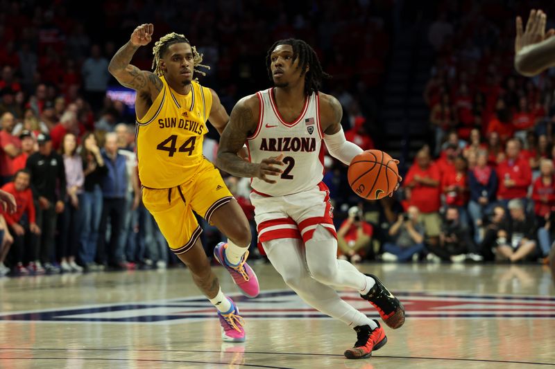 Feb 17, 2024; Tucson, Arizona, USA; Arizona Wildcats guard Caleb Love (2) drives to the net against Arizona State Sun Devils guard Adam Miller (44) during the second half at McKale Center. Mandatory Credit: Zachary BonDurant-USA TODAY Sports