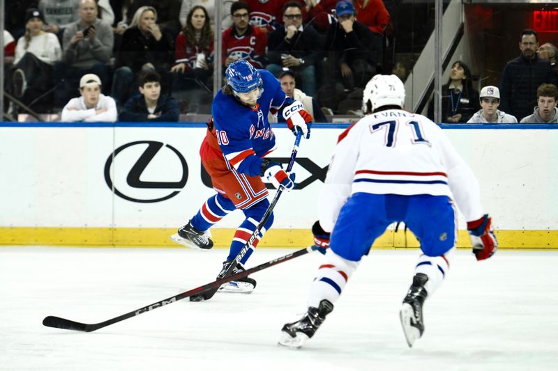 Nov 30, 2024; New York, New York, USA; New York Rangers left wing Artemi Panarin (10) shoots and scores a goal as Montreal Canadiens center Jake Evans (71) defends during the first period at Madison Square Garden. Mandatory Credit: John Jones-Imagn Images