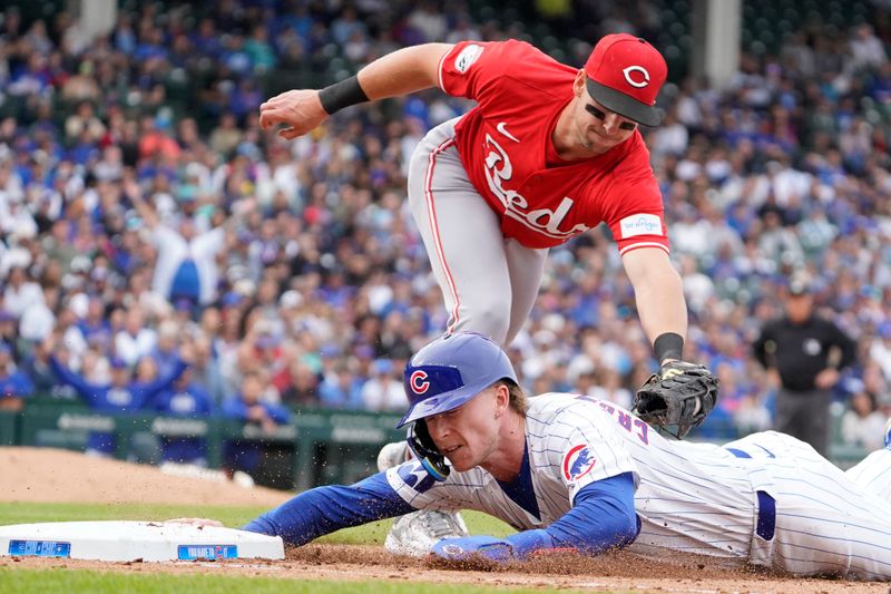 Sep 27, 2024; Chicago, Illinois, USA; Chicago Cubs outfielder Pete Crow-Armstrong (52) is picked off of first base as Cincinnati Reds first baseman Spencer Steer (7) tags him out during the eighth inning at Wrigley Field. Mandatory Credit: David Banks-Imagn Images