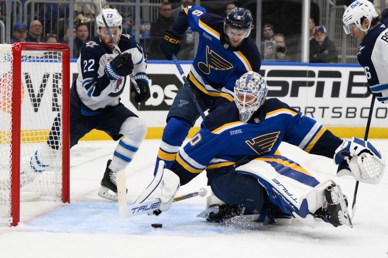 Apr 27, 2025; St. Louis, Missouri, USA; St. Louis Blues goaltender Jordan Binnington (50) makes a save against the Winnipeg Jets during the first period in game four of the first round of the 2025 Stanley Cup Playoffs at Enterprise Center. Mandatory Credit: Jeff Le-Imagn Images