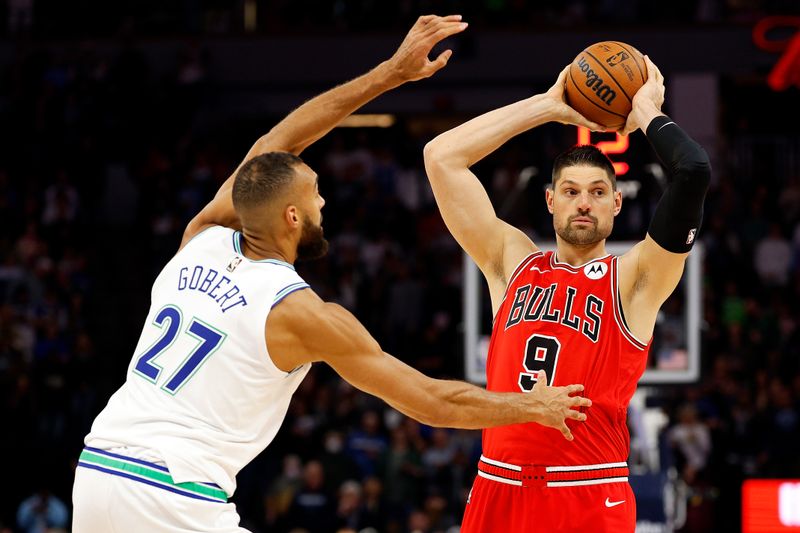 MINNEAPOLIS, MINNESOTA - MARCH 31: Nikola Vucevic #9 of the Chicago Bulls looks to pass against Rudy Gobert #27 of the Minnesota Timberwolves in the first quarter at Target Center on March 31, 2024 in Minneapolis, Minnesota. NOTE TO USER: User expressly acknowledges and agrees that, by downloading and or using this photograph, User is consenting to the terms and conditions of the Getty Images License Agreement. (Photo by David Berding/Getty Images)