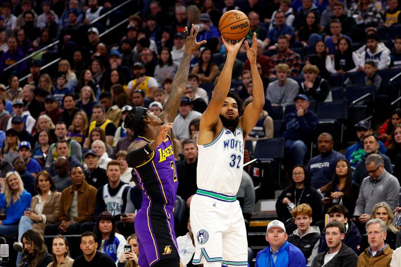 MINNEAPOLIS, MINNESOTA - DECEMBER 30: Karl-Anthony Towns #32 of the Minnesota Timberwolves shoots the ball while Jarred Vanderbilt #2 of the Los Angeles Lakers defends in the first quarter at Target Center on December 30, 2023 in Minneapolis, Minnesota. NOTE TO USER: User expressly acknowledges and agrees that, by downloading and or using this photograph, User is consenting to the terms and conditions of the Getty Images License Agreement. (Photo by David Berding/Getty Images)