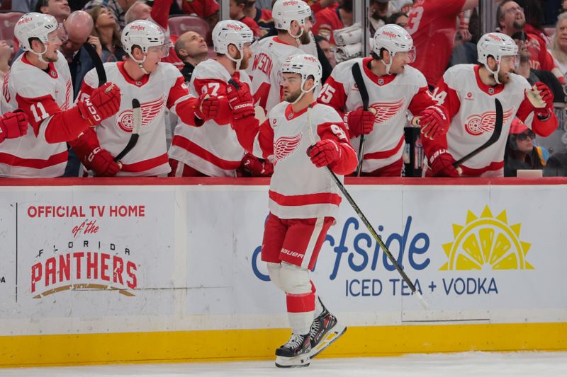 Apr 10, 2025; Sunrise, Florida, USA; Detroit Red Wings right wing Alex DeBrincat (93) celebrates with teammates after scoring against the Florida Panthers during the first period at Amerant Bank Arena. Mandatory Credit: Sam Navarro-Imagn Images