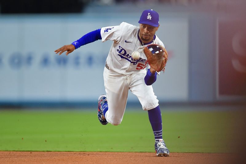 Apr 3, 2024; Los Angeles, California, USA; Los Angeles Dodgers second baseman Mookie Betts (50) fields the ground ball of San Francisco Giants center fielder Jung Hoo Lee (51) during the sixth inning at Dodger Stadium. Mandatory Credit: Gary A. Vasquez-USA TODAY Sports