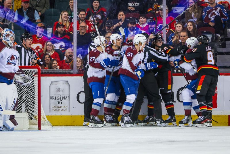 Mar 12, 2024; Calgary, Alberta, CAN; Calgary Flames center Martin Pospisil (76) gets into a scrum with Colorado Avalanche defenseman Josh Manson (42) during the first period at Scotiabank Saddledome. Mandatory Credit: Sergei Belski-USA TODAY Sports