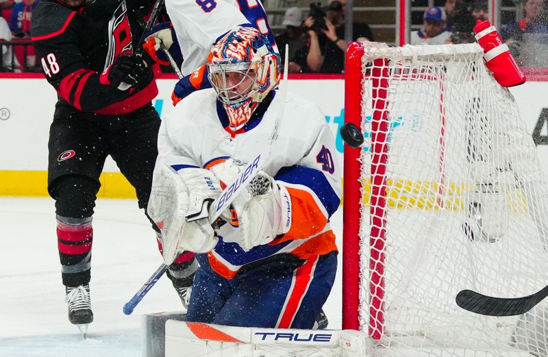 Apr 30, 2024; Raleigh, North Carolina, USA; New York Islanders goaltender Semyon Varlamov (40) clears the shot  away against the Carolina Hurricanes during the first period in game five of the first round of the 2024 Stanley Cup Playoffs at PNC Arena. Mandatory Credit: James Guillory-USA TODAY Sports