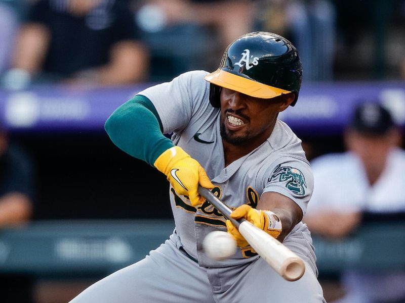 Jul 28, 2023; Denver, Colorado, USA; Oakland Athletics left fielder Tony Kemp (5) with an RBI bunt in the second inning against the Colorado Rockies at Coors Field. Mandatory Credit: Isaiah J. Downing-USA TODAY Sports