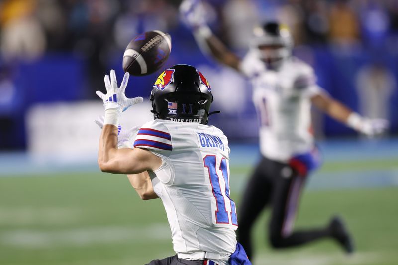 Nov 16, 2024; Provo, Utah, USA; Kansas Jayhawks wide receiver Luke Grimm (11) catches a pass against the Brigham Young Cougars during the second quarter at LaVell Edwards Stadium. Mandatory Credit: Rob Gray-Imagn Images