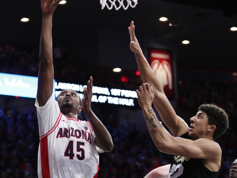 Feb 18, 2023; Tucson, Arizona, USA; Arizona Wildcats guard Cedric Henderson Jr. (45) makes a basket against Colorado Buffaloes guard Nique Clifford (32) during the second half at McKale Center. Mandatory Credit: Zachary BonDurant-USA TODAY Sports