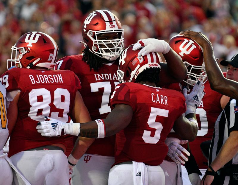 Sep 11, 2021; Bloomington, Indiana, USA; The Indiana Hoosiers celebrate after a touchdown against the Idaho Vandals during the first quarter at Memorial Stadium. Mandatory Credit: Marc Lebryk-USA TODAY Sports