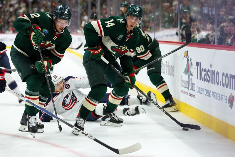 Oct 10, 2024; Saint Paul, Minnesota, USA; Minnesota Wild center Joel Eriksson Ek (14) skates with the puck against the Columbus Blue Jackets during the second period at Xcel Energy Center. Mandatory Credit: Matt Krohn-Imagn Images