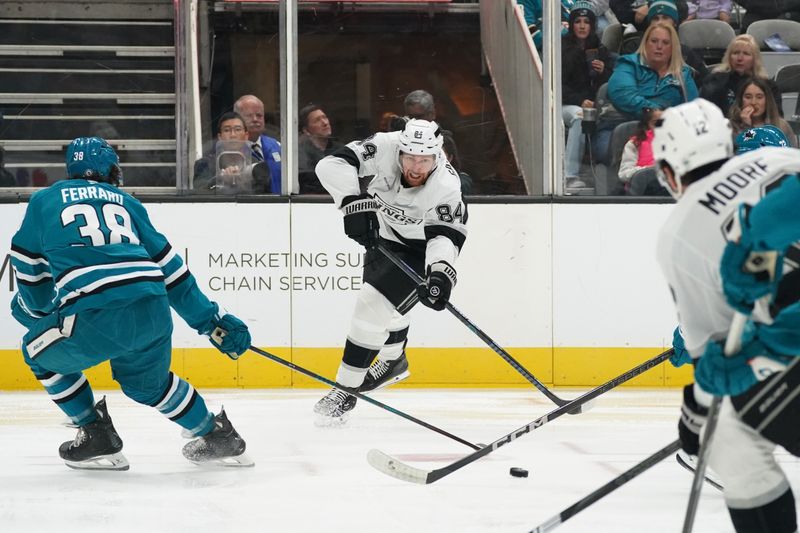 Nov 25, 2024; San Jose, California, USA; Los Angeles Kings defenseman Vladislav Gavrikov (84) makes a pass against San Jose Sharks defenseman Mario Ferraro (38) in the first period at SAP Center at San Jose. Mandatory Credit: David Gonzales-Imagn Images