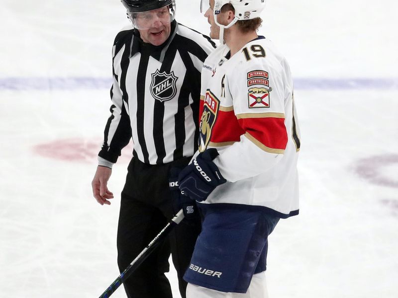 Dec 3, 2024; Pittsburgh, Pennsylvania, USA;  Florida Panthers left wing Matthew Tkachuk (19) talks with linesman Michel Cormier (left) against the Pittsburgh Penguins during the first period at PPG Paints Arena. Mandatory Credit: Charles LeClaire-Imagn Images