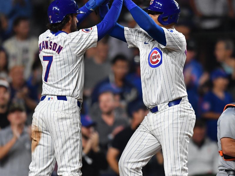 Aug 21, 2024; Chicago, Illinois, USA; Chicago Cubs catcher Christian Bethancourt (right) celebrates his two-run home run with shortstop Dansby Swanson (left) during the fifth inning against the Detroit Tigers at Wrigley Field. Mandatory Credit: Patrick Gorski-USA TODAY Sports