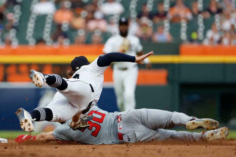Jun 12, 2024; Detroit, Michigan, USA;  Detroit Tigers shortstop Zach McKinstry (39) makes a diving tag to get Washington Nationals center fielder Jacob Young (30) out at second in the sixth inning at Comerica Park. Mandatory Credit: Rick Osentoski-USA TODAY Sports