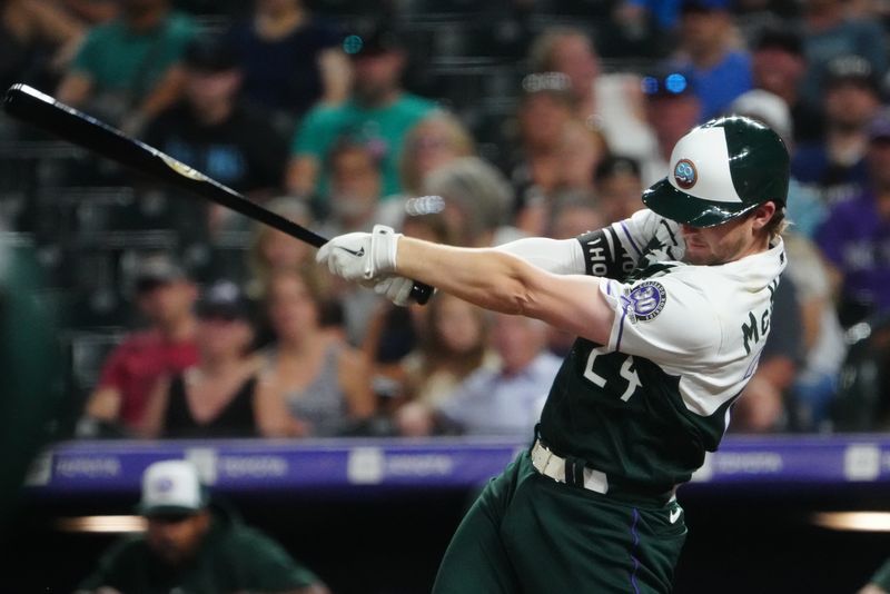 Sep 2, 2023; Denver, Colorado, USA; Colorado Rockies third baseman Ryan McMahon (24) singles against the Toronto Blue Jays in the eighth inning at Coors Field. Mandatory Credit: Ron Chenoy-USA TODAY Sports