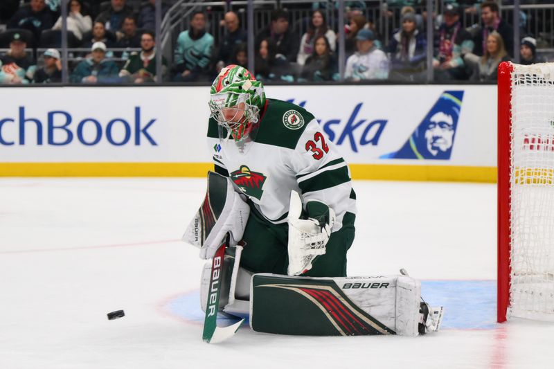 Dec 10, 2023; Seattle, Washington, USA; Minnesota Wild goaltender Filip Gustavsson (32) blocks a goal shot against the Seattle Kraken during the second period at Climate Pledge Arena. Mandatory Credit: Steven Bisig-USA TODAY Sports