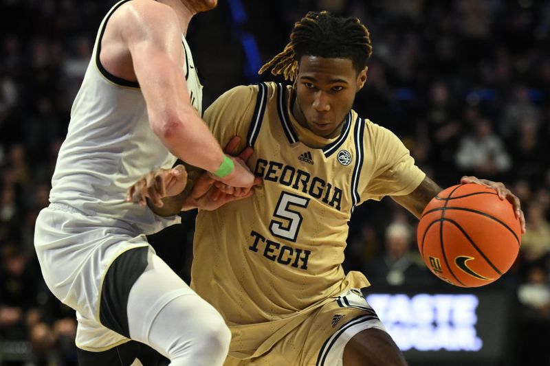 Feb 11, 2023; Winston-Salem, North Carolina, USA; Georgia Tech Yellow Jackets guard Deivon Smith (5) drives against Wake Forest Demon Deacons guard Cameron Hildreth (2) during the second half at Lawrence Joel Veterans Memorial Coliseum. Mandatory Credit: William Howard-USA TODAY Sports