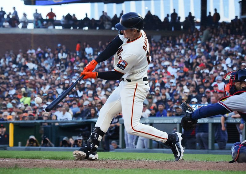 Aug 27, 2023; San Francisco, California, USA; San Francisco Giants catcher Patrick Bailey (14) hits a three-run RBI double against the Atlanta Braves during the fifth inning at Oracle Park. Mandatory Credit: Kelley L Cox-USA TODAY Sports