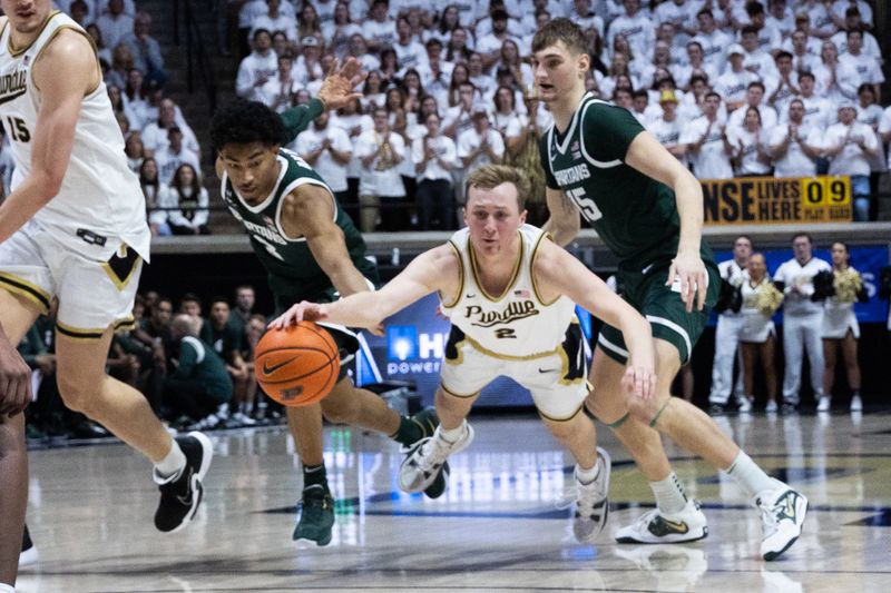 Jan 29, 2023; West Lafayette, Indiana, USA;  Purdue Boilermakers guard Fletcher Loyer (2) dives for the ball while Michigan State Spartans guard Jaden Akins (3) and center Carson Cooper (15) defend in the second half at Mackey Arena. Mandatory Credit: Trevor Ruszkowski-USA TODAY Sports