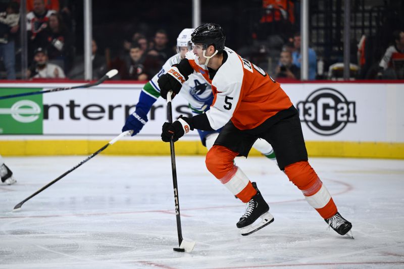 Oct 19, 2024; Philadelphia, Pennsylvania, USA; Philadelphia Flyers defenseman Egor Zamula (5) controls the puck against the Vancouver Canucks in the third period at Wells Fargo Center. Mandatory Credit: Kyle Ross-Imagn Images