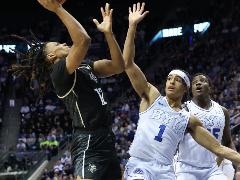 Feb 13, 2024; Provo, Utah, USA; Central Florida Knights guard DeMarr Langford Jr.(12) shoots over Brigham Young Cougars guard Trey Stewart (1) during the first half at Marriott Center. Mandatory Credit: Rob Gray-USA TODAY Sports