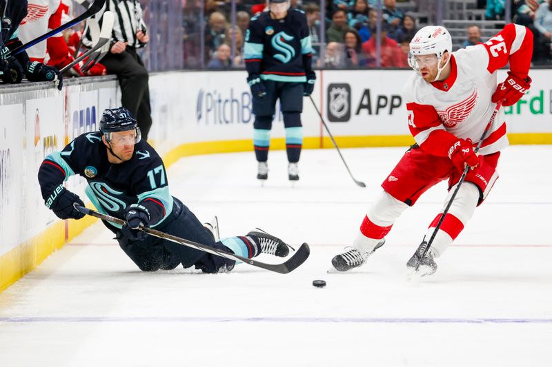 Feb 19, 2024; Seattle, Washington, USA; Seattle Kraken center Jaden Schwartz (17) passes the puck away from Detroit Red Wings left wing J.T. Compher (37) during the second period at Climate Pledge Arena. Mandatory Credit: Joe Nicholson-USA TODAY Sports