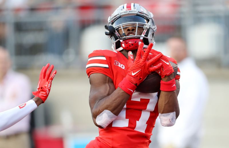 Sep 16, 2023; Columbus, Ohio, USA; Ohio State Buckeyes wide receiver Carnell Tate (17) catches a touchdown pass during the fourth quarter against the Western Kentucky Hilltoppers at Ohio Stadium. Mandatory Credit: Joseph Maiorana-USA TODAY Sports