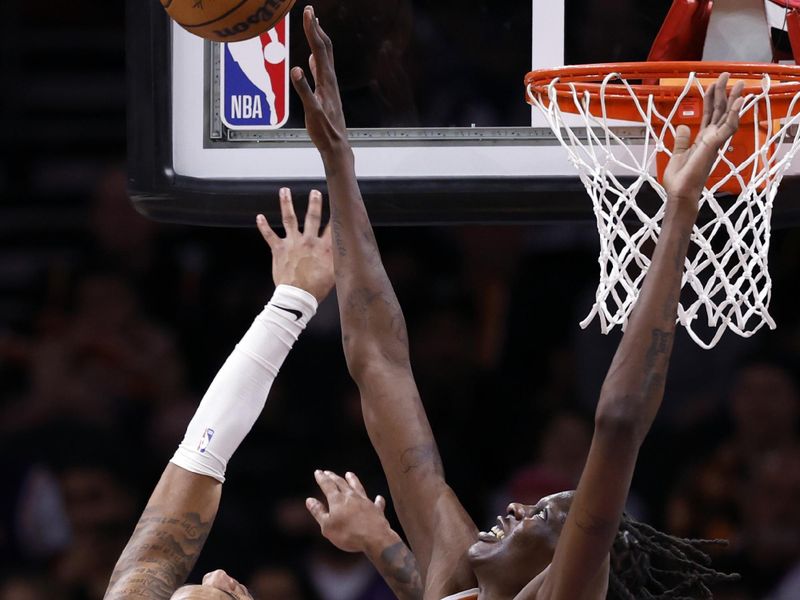 PHOENIX, ARIZONA - MARCH 02: Bol Bol #11 of the Phoenix Suns blocks a shot by Cam Whitmore #7 of the Houston Rockets during the first half at Footprint Center on March 02, 2024 in Phoenix, Arizona. NOTE TO USER: User expressly acknowledges and agrees that, by downloading and or using this photograph, User is consenting to the terms and conditions of the Getty Images License Agreement.  (Photo by Chris Coduto/Getty Images)