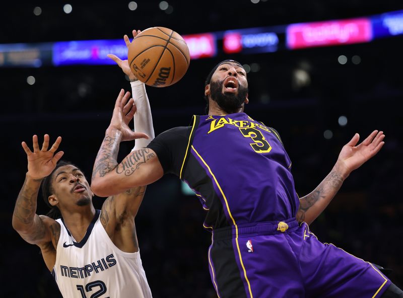 LOS ANGELES, CALIFORNIA - JANUARY 05: Anthony Davis #3 of the Los Angeles Lakers reacts as he is stripped of the ball by Ja Morant #12 of the Memphis Grizzlies during the first half at Crypto.com Arena on January 05, 2024 in Los Angeles, California. User is consenting to the terms and conditions of the Getty Images License Agreement. (Photo by Harry How/Getty Images)