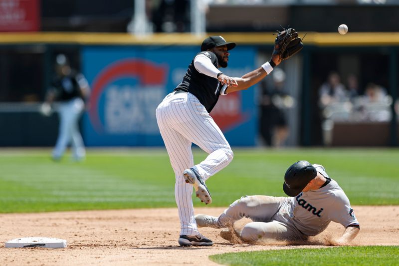 Jun 10, 2023; Chicago, Illinois, USA; Miami Marlins shortstop Joey Wendle (18) steals second base as Chicago White Sox shortstop Elvis Andrus (1) waits for the ball during the second inning at Guaranteed Rate Field. Mandatory Credit: Kamil Krzaczynski-USA TODAY Sports