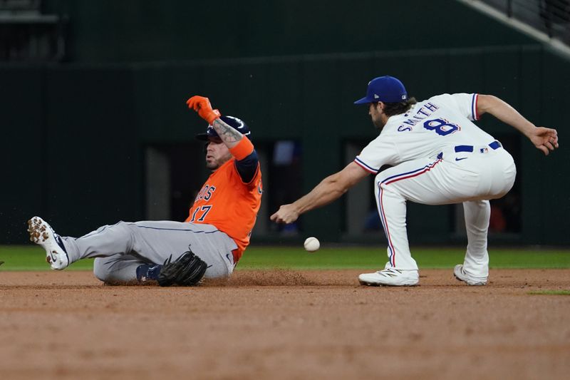 May 15, 2025; Arlington, Texas, USA; Houston Astros catcher Victor Caratini (17) slides into second base with a double as Texas Rangers shortstop Josh Smith (8) can not handle the throw during the second inning at Globe Life Field. Mandatory Credit: Raymond Carlin III-Imagn Images