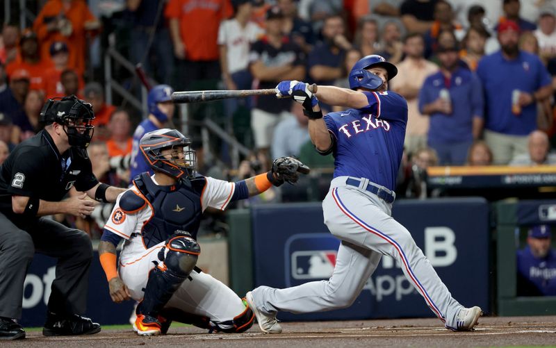 Oct 23, 2023; Houston, Texas, USA; Texas Rangers shortstop Corey Seager (5) hits a home run during the first inning of game seven in the ALCS against the Houston Astros for the 2023 MLB playoffs at Minute Maid Park. Mandatory Credit: Erik Williams-USA TODAY Sports